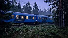 KI-Visual von Wagen des RDC EuroNight, die durch einen Wald bei Dämmerung fahren.