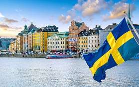 View over the water towards Stockholm with a Swedish flag in the foreground.